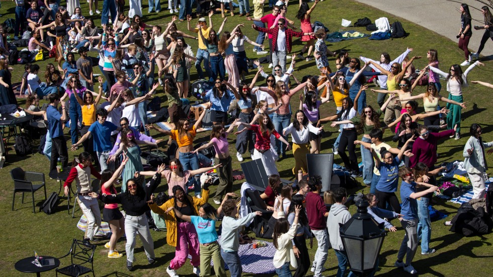 crowd of students dances on College Green