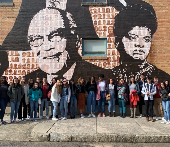 Students standing in front of a mural of civil rights leaders in Memphis, TN.