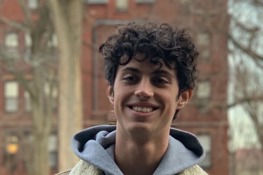 Lucas Capovila Headshot in front of a Brown Dorm