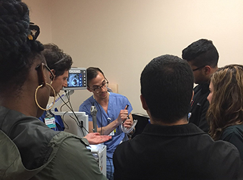 Image of residents observing a faculty member demonstrate use of anesthesiology equipment