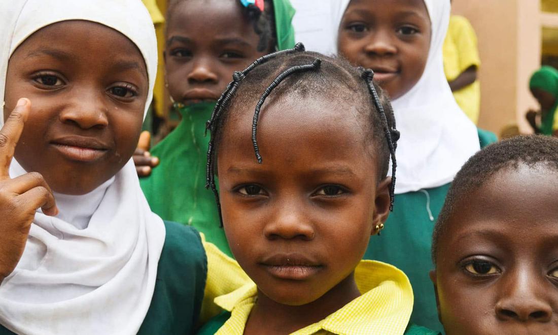 Photo of male and female African students in their school uniforms