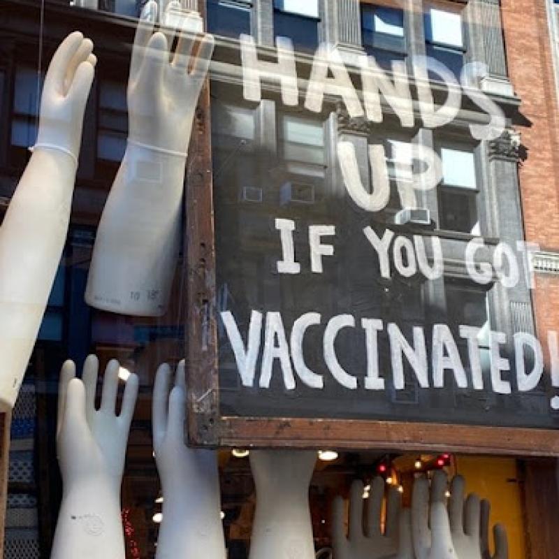 Art image of large sculpted hands along with caption that reads: Hands Up if you Got Vaccinated