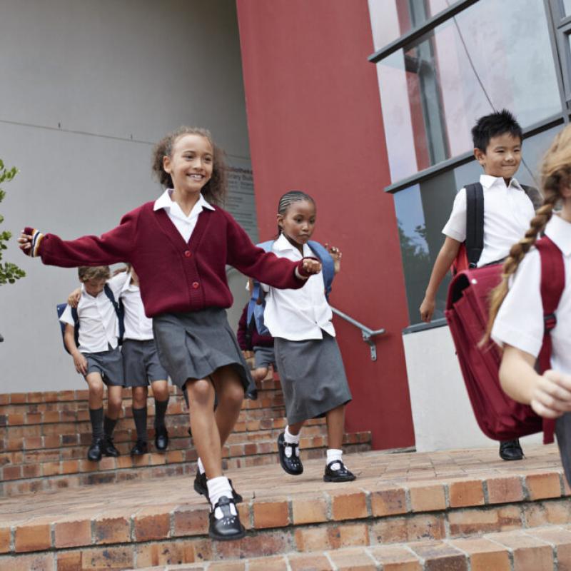 Uniformed school children leaving a school building