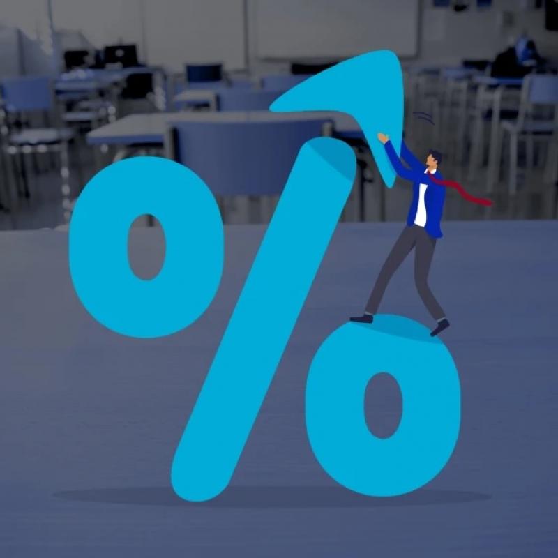 Image of arrow pointing up in front of an empty classroom
