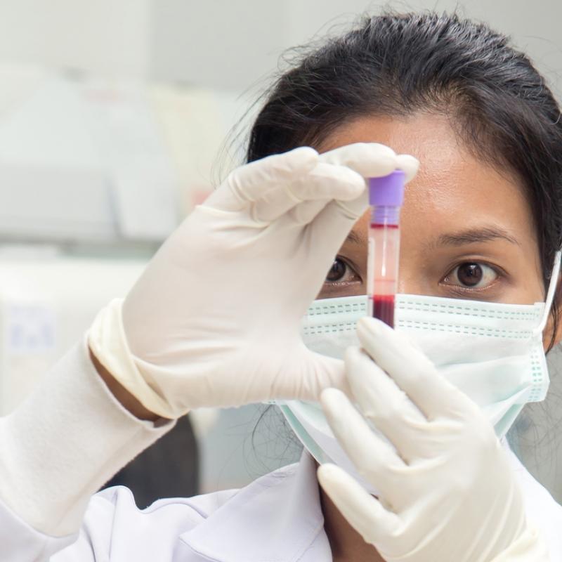 Scientist examines vial