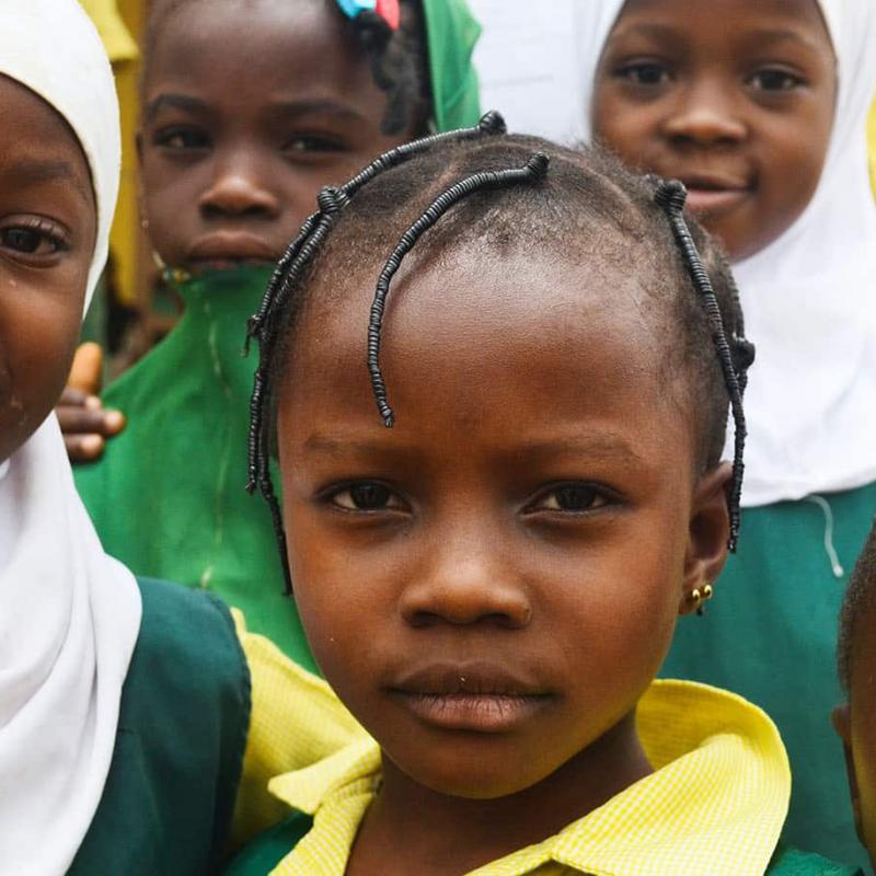 Photo of male and female African students in their school uniforms