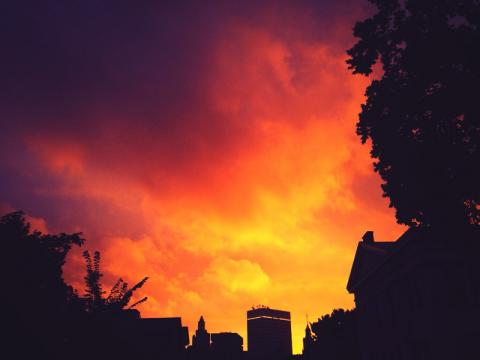 image of sun setting and clouds over Brown University campus