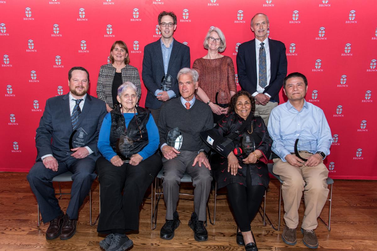 Photo of the 2023 Research Achievement Award Winners, Provost, and Vice President for Research in front of a Brown backdrop