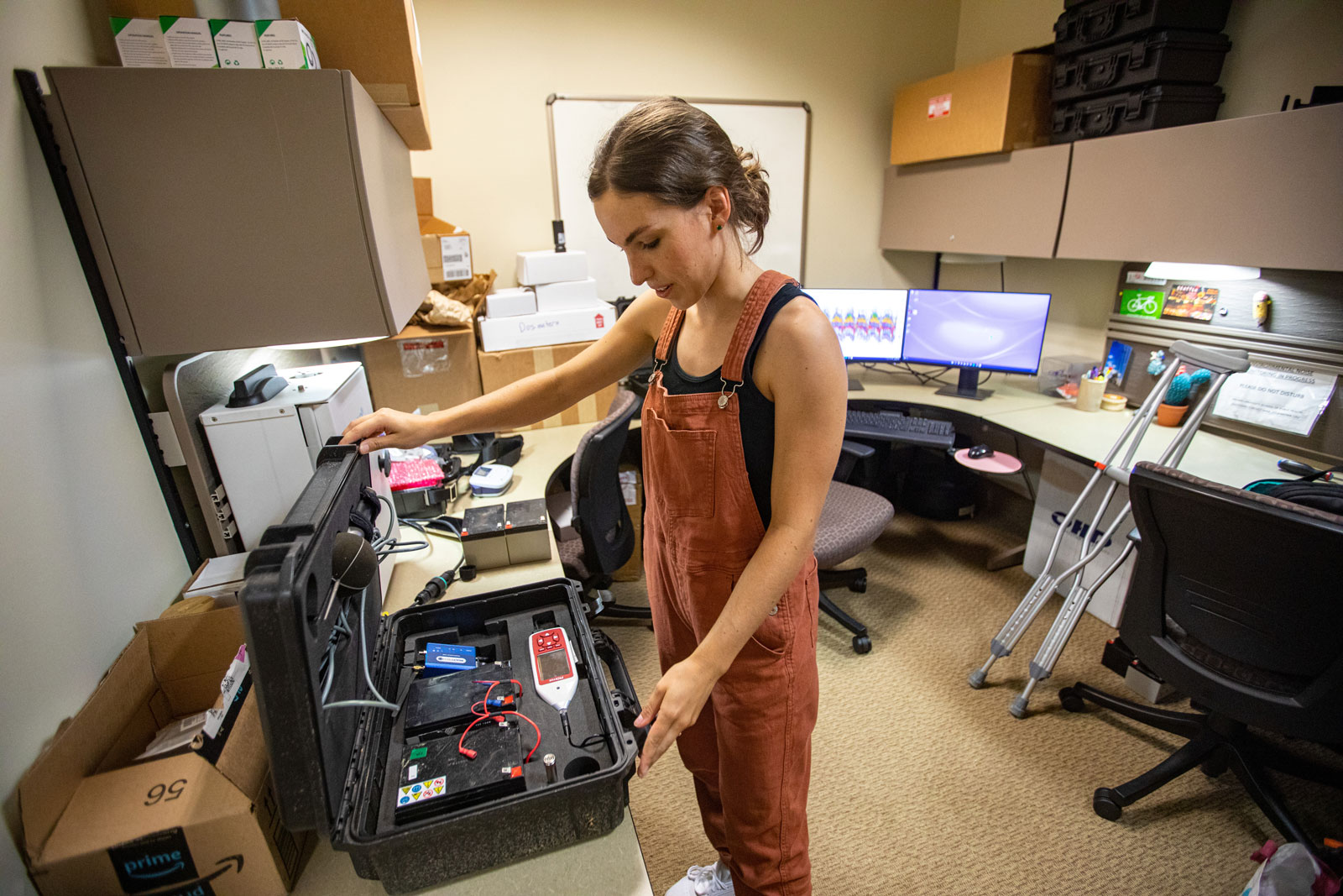 Lee unpacks the monitor in her office