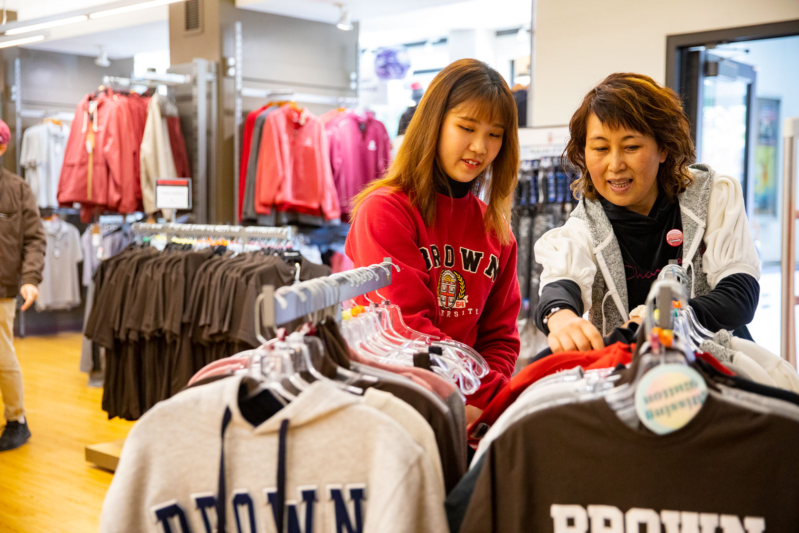 Lee and a shopper browse the racks