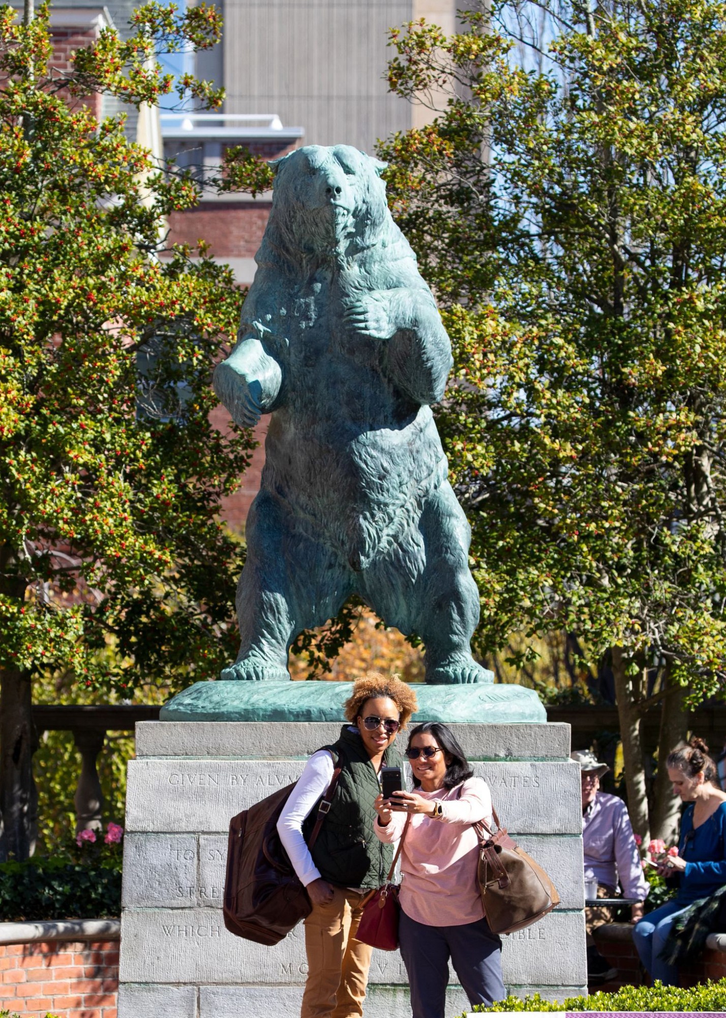 People pose for photo in front of Bronze Bruno