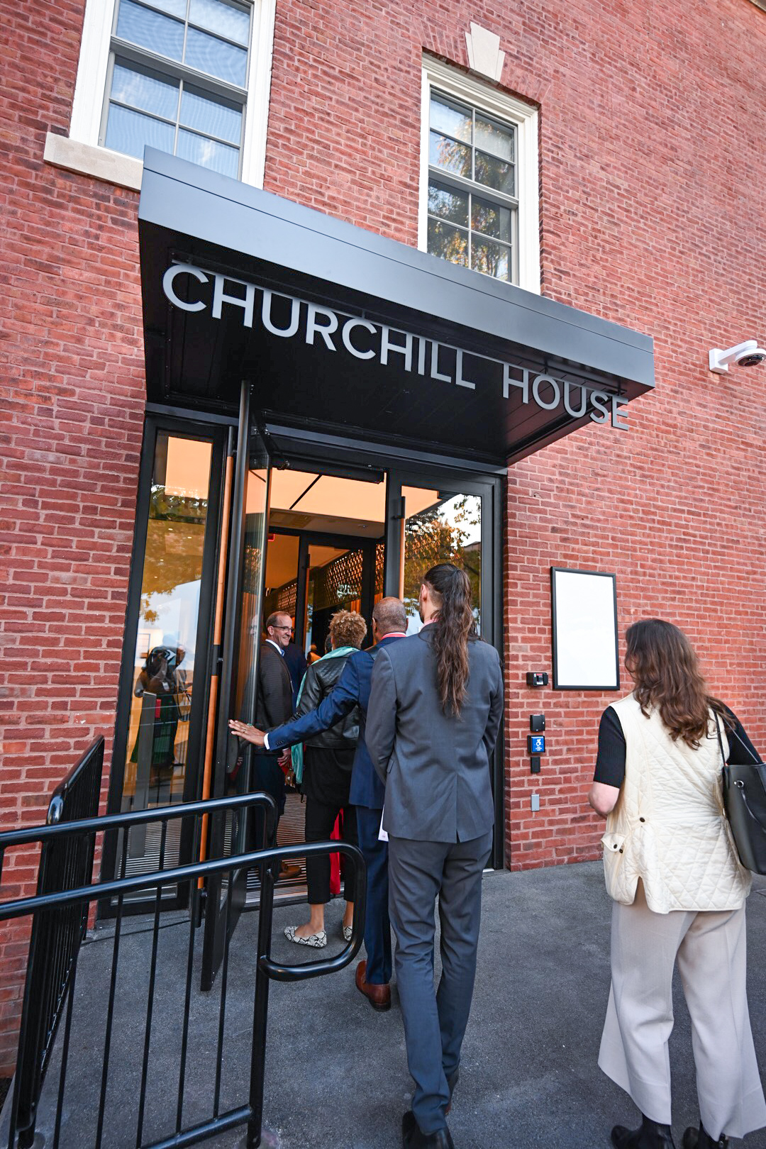 Attendees enter the new Churchill House doorway