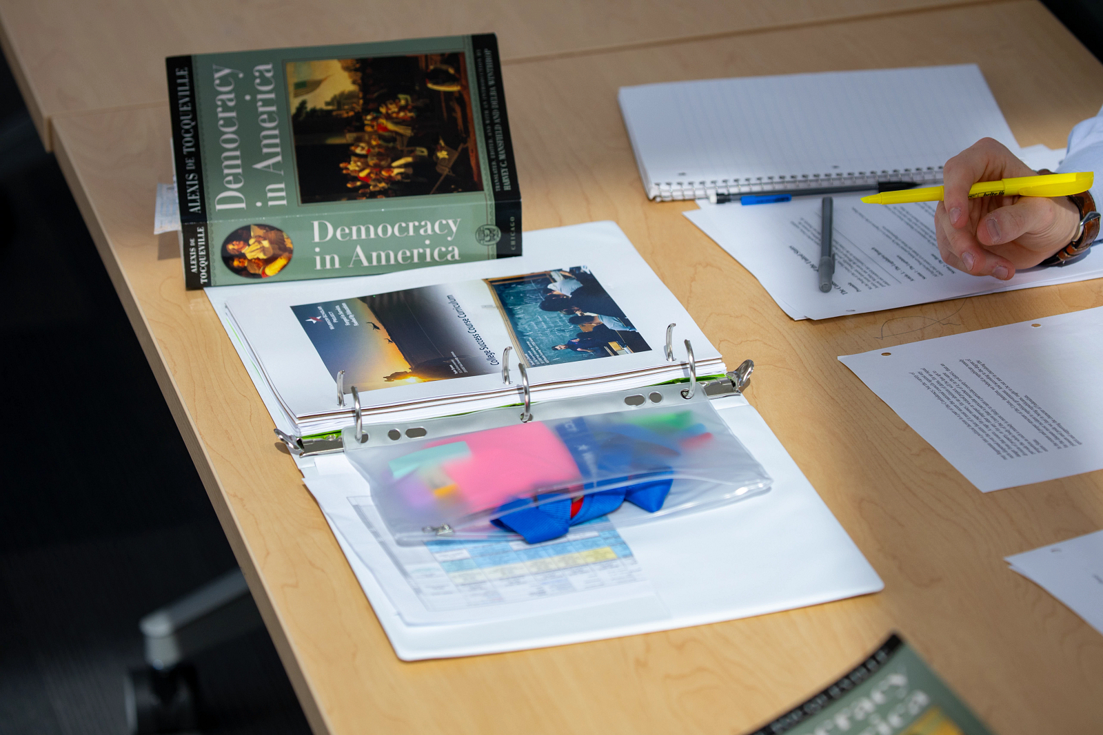 Detail shot of textbook and writing materials