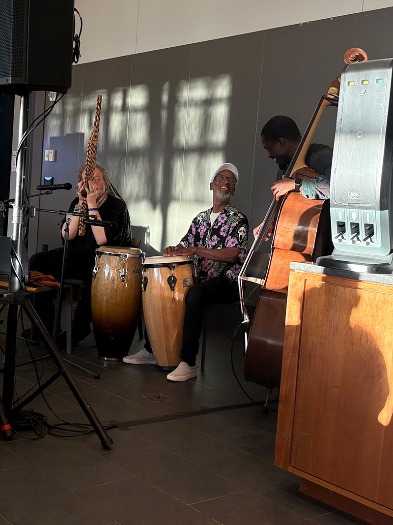 a jazz combo with bass, congas and flute
