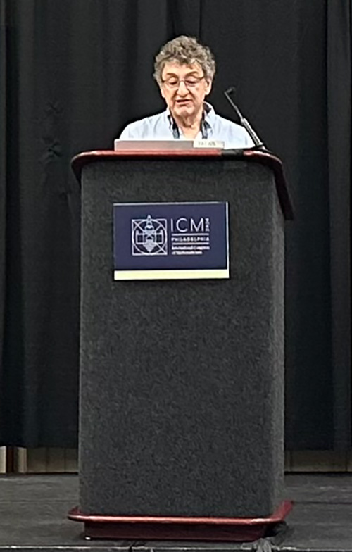 a person speaking at a lecturn