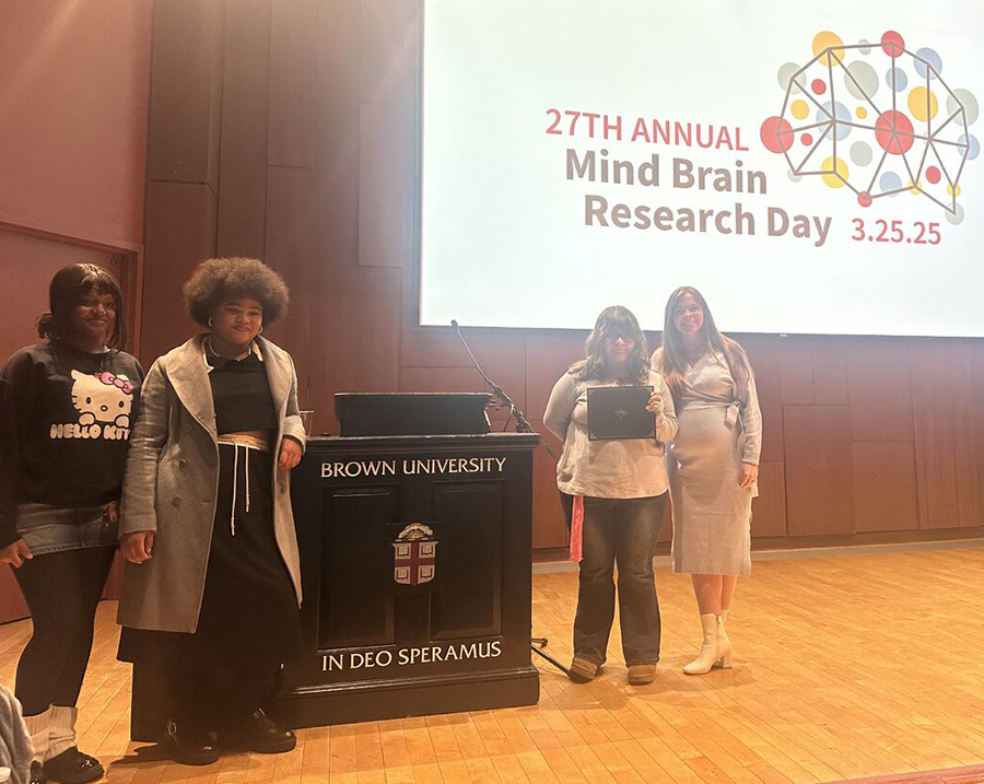 Providene teens pose on a stage at Brown's mind brain research day