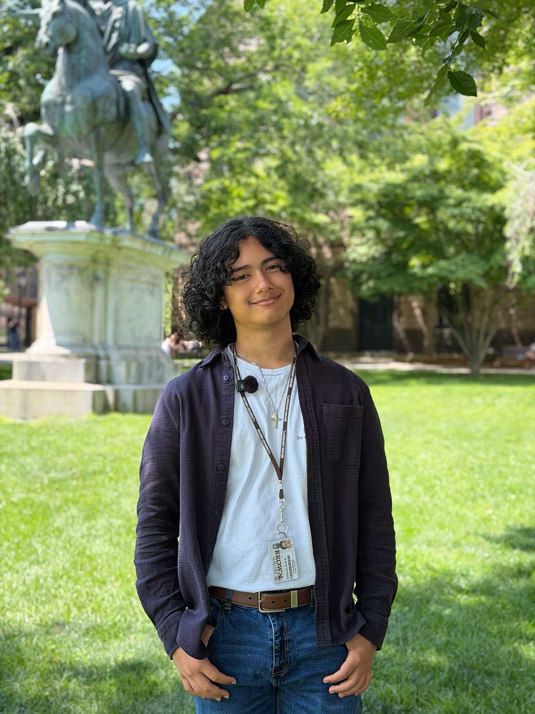 Providence teen smiles on the campus green on Brown's campus.