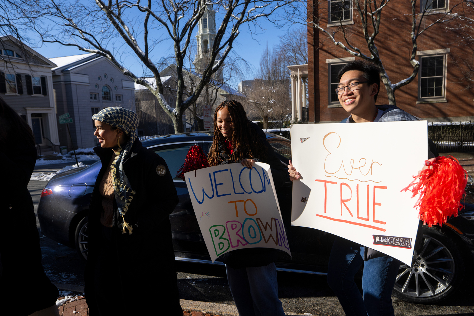 Students hold up welcome signs
