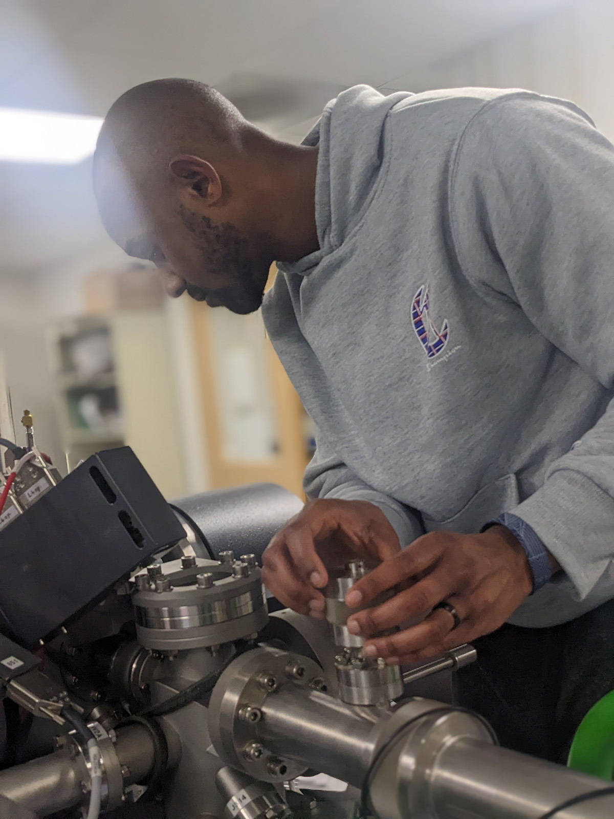 A scientist places a sample in a research device
