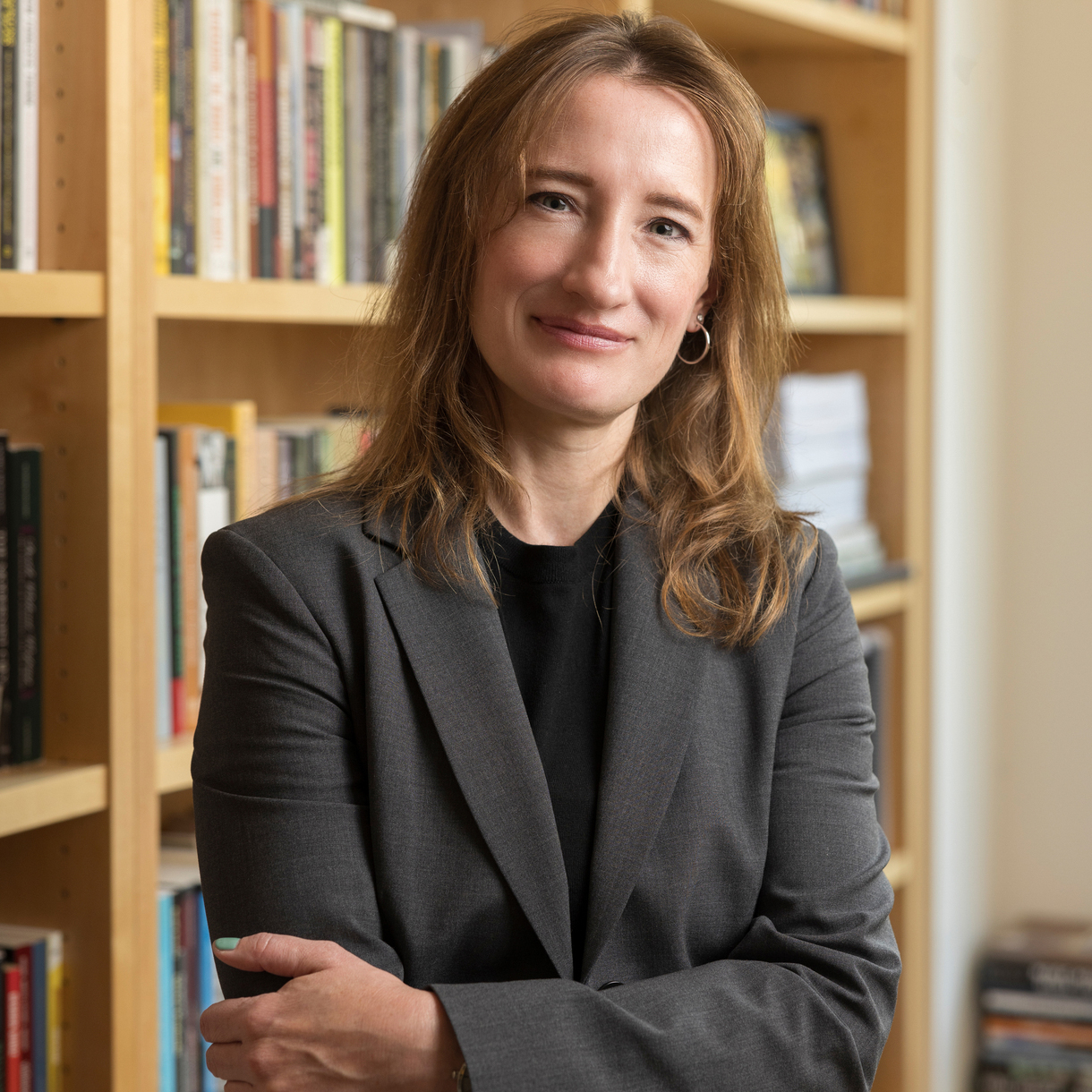 Ieva Jusionyte poses in front of a bookshelf