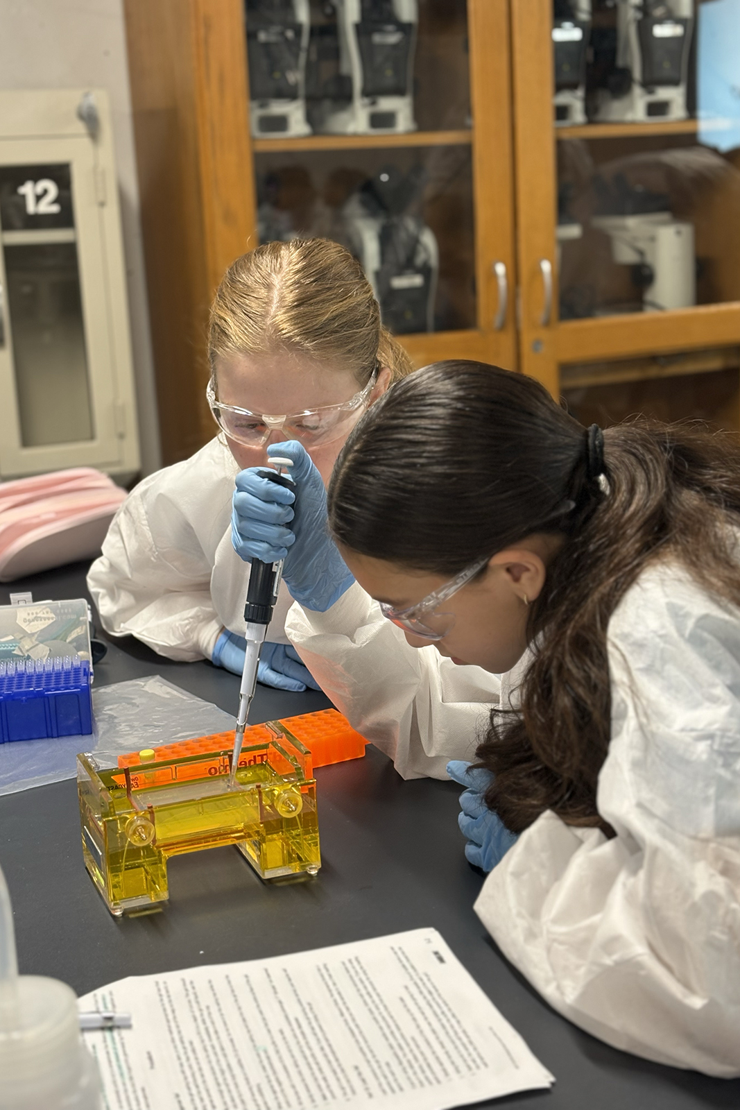 Students use pipette in lab class