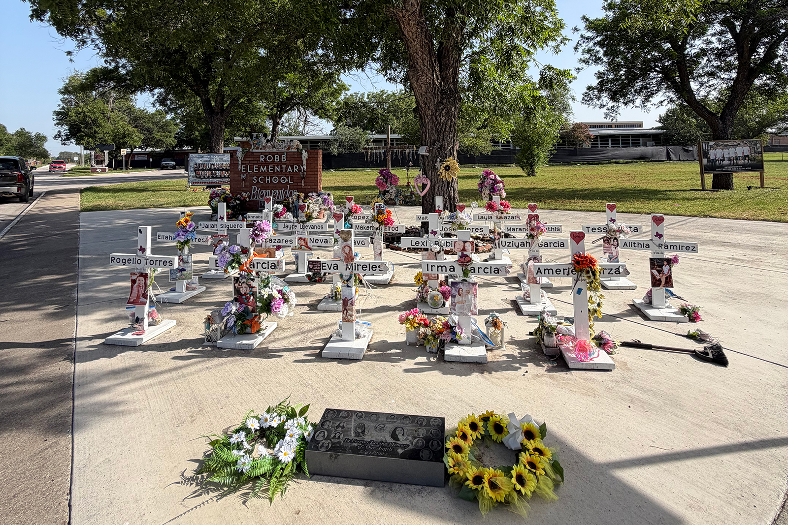 21 crosses sit mark a memorial at Robb Elementary School in Uvalde, Texas