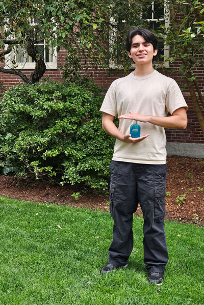 Daren Crespo holds a bottle of cologne