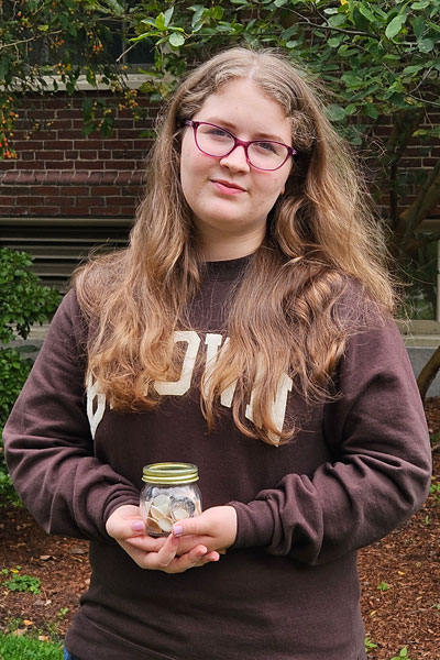 Hannah Legault holds a jar of seashells
