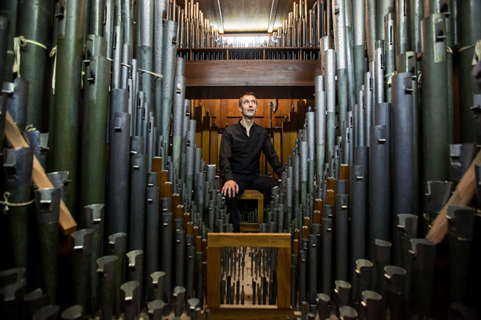Mark Steinbach among the pipes of the organ at Sayles Hall