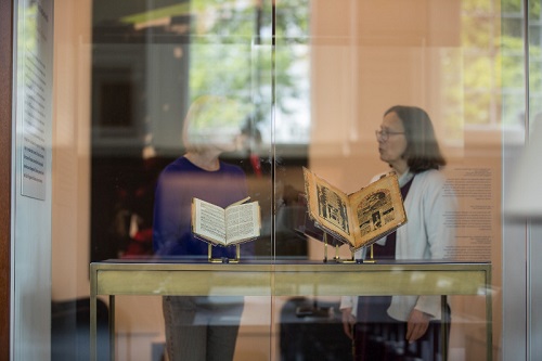 Holly Snyder discusses the Haggadot with a visitor