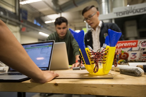 Luke Morales and Matthew Lo test a prosthetic socket prototype