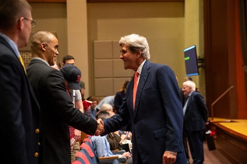 John Kerry shaking hands with military veterans and students