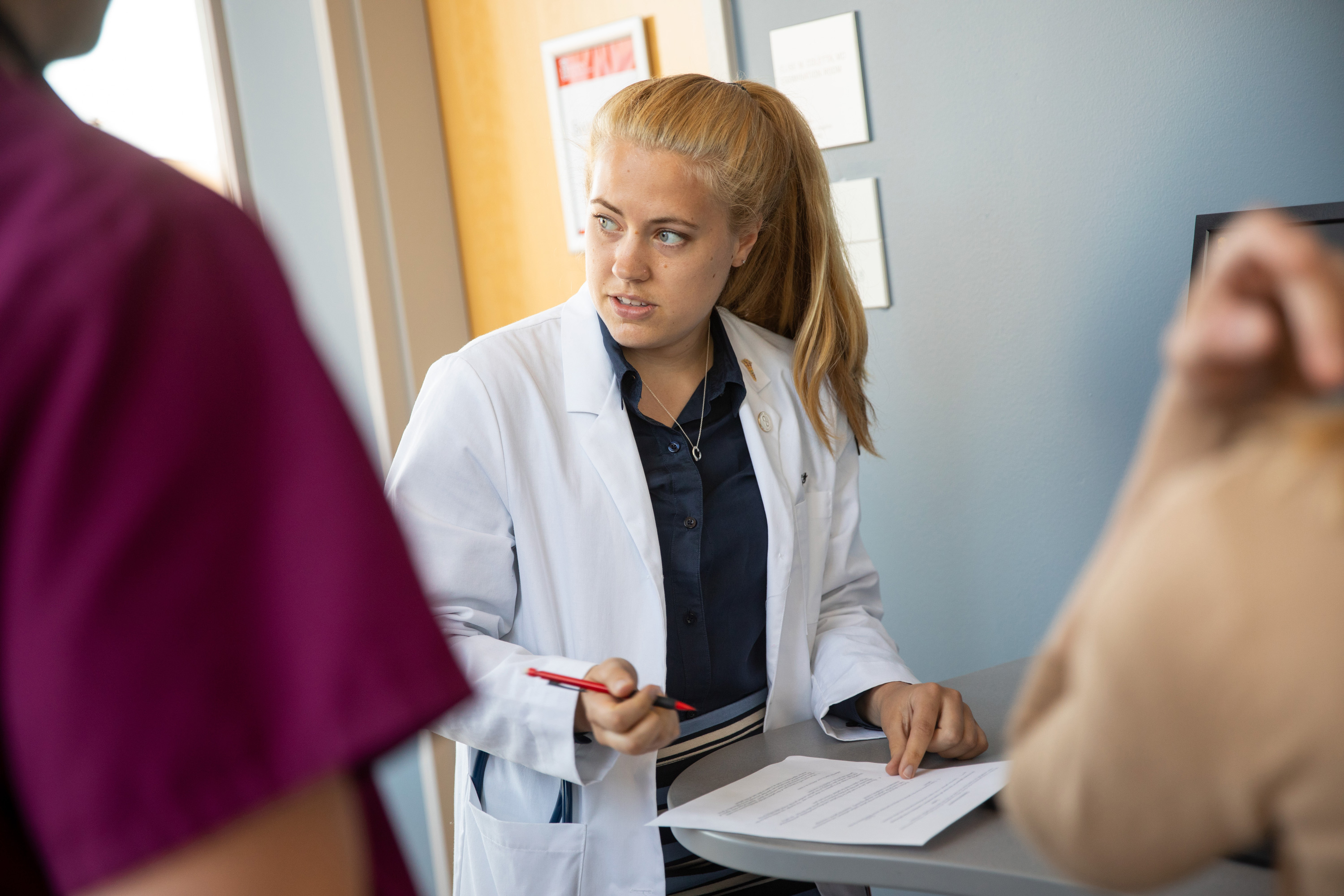 Erica Veazey, a Class of 2021 medical student from Brown University, consults with her team at the opioid use workshop.