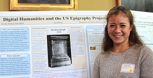 Anya Hong poses in front of her poster on her summer research in Classics