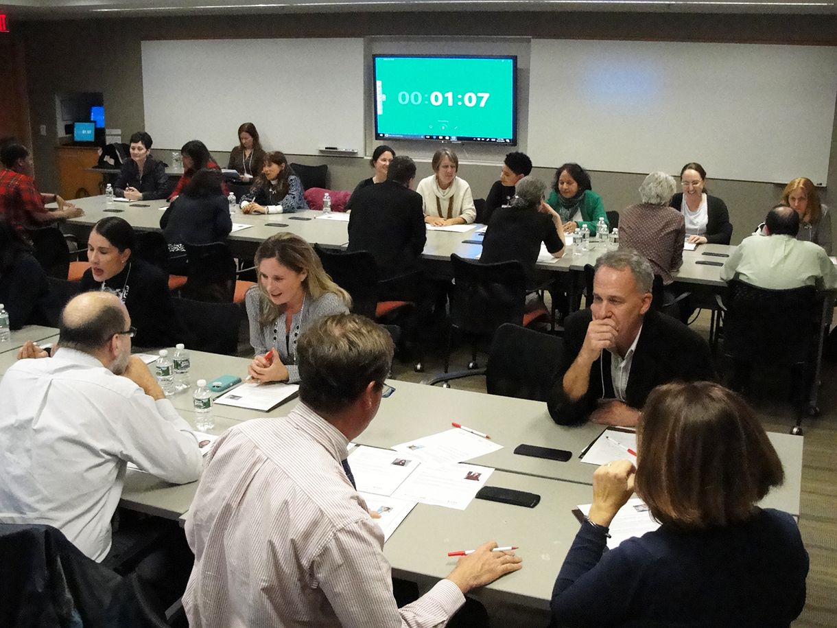 Researchers at tables engaging in "speed networking"