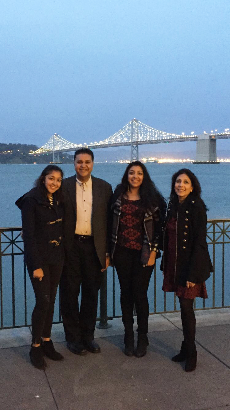 The Mittals posing in front of the Newport Bridge