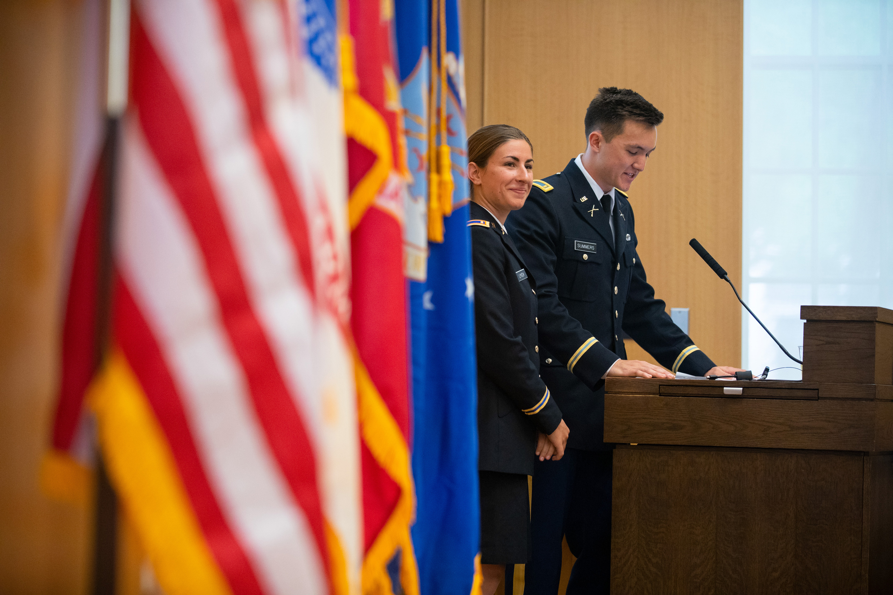 New officers Lynch and Summers speak to friends, family and special guests during the Graduating Veterans Recognition and Commissioning Ceremony