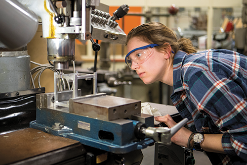 Lauren Haller works on EQUiSat’s custom-milled aluminum chassis