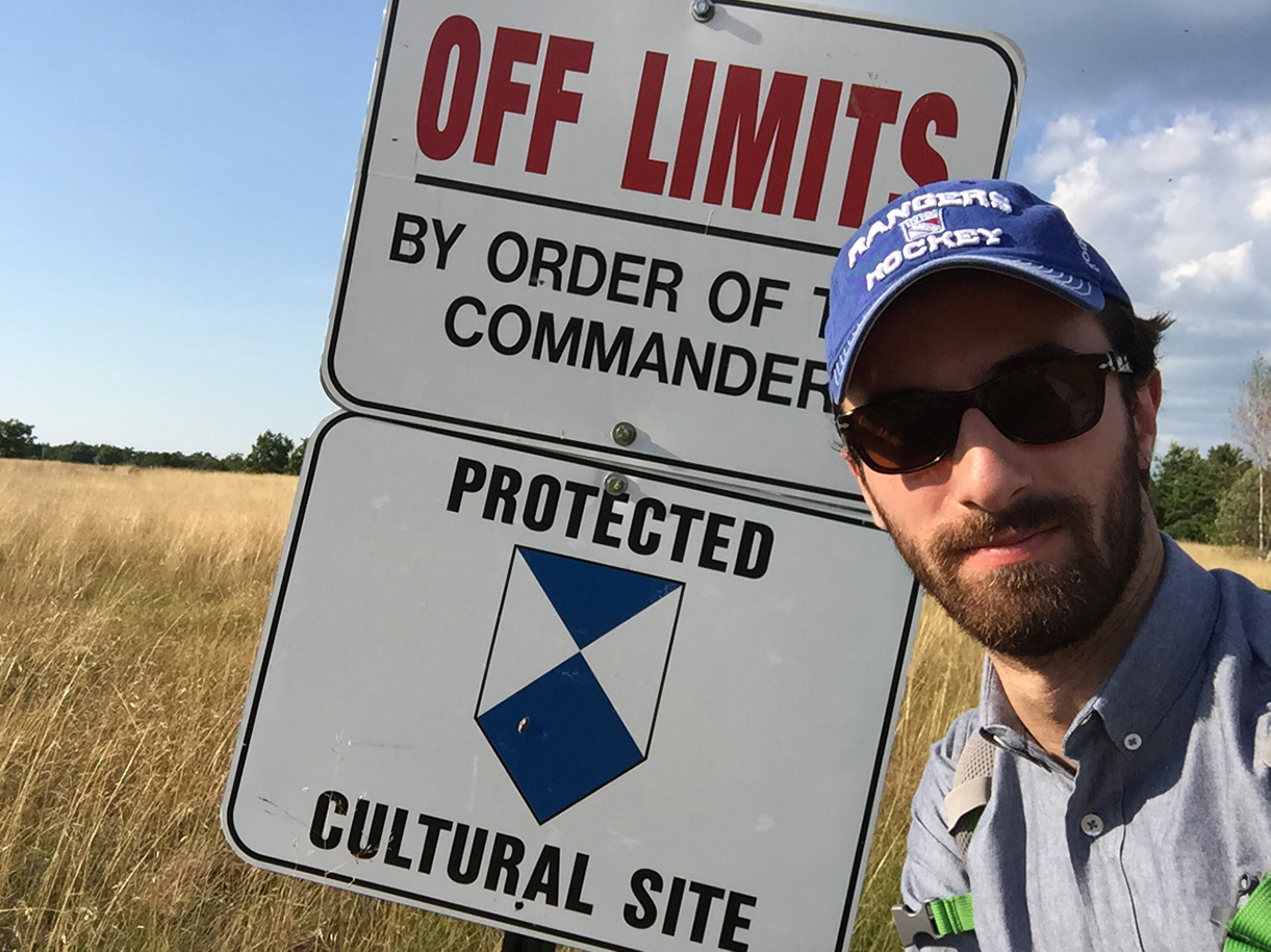 David Elitzer standing in front of an "Off Limits" sign in Fort Drum