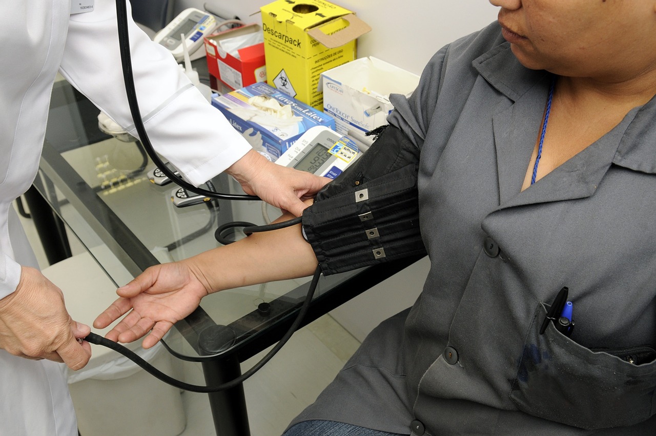 Doctor taking patient's blood pressure