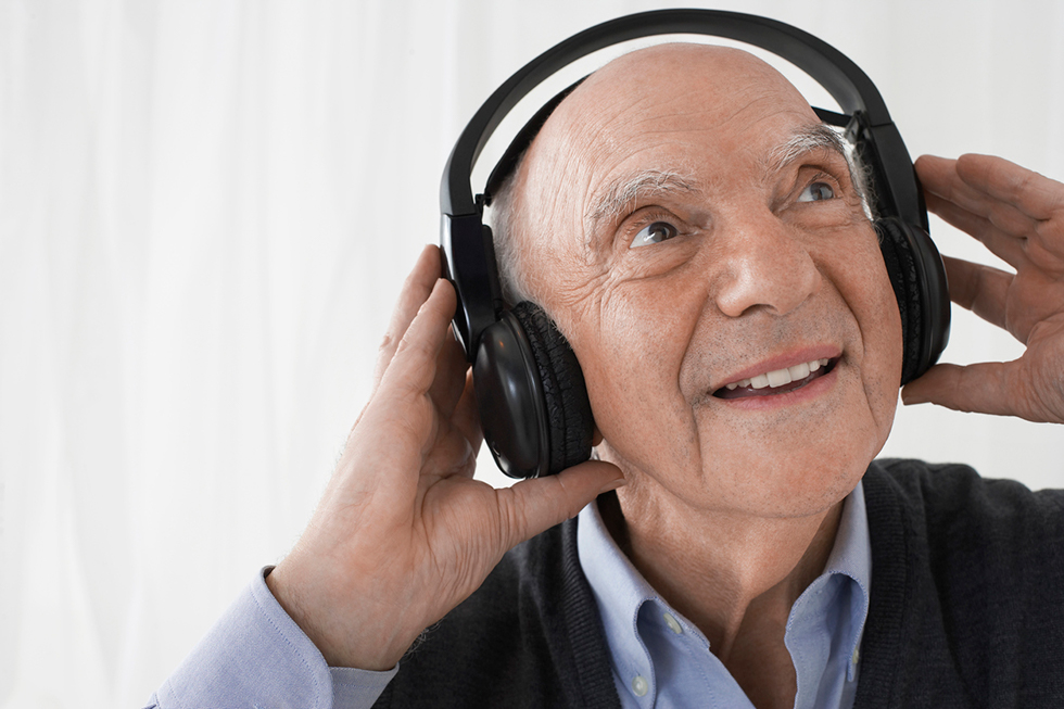 Older man listening to headphones