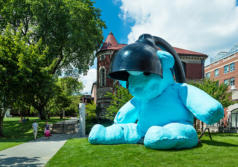 Lamp/Bear sculpture - building-sized neon blue plush bear attached to a black desk lamp