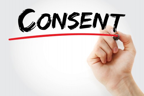 The word consent hand-written in marker