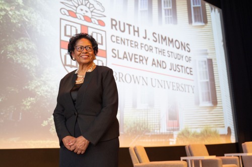 Ruth J. Simmons standing in front of a large projector screen