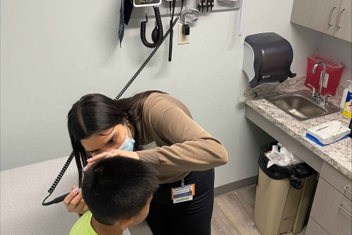 Brown medical school student working at SMART Plus Clinic