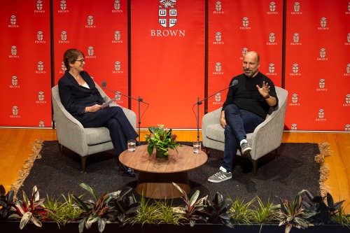 Dara Khosrowshahi and Christina Paxson seated on the stage