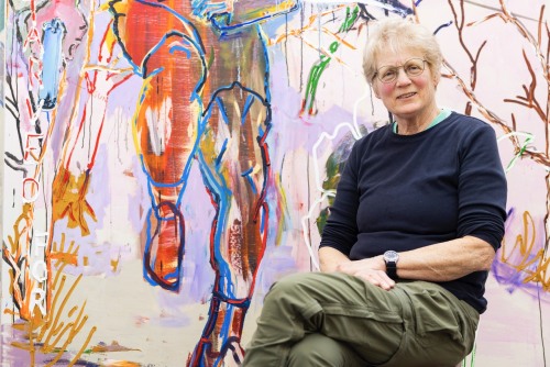 Leslie Bostrom in front of a painting