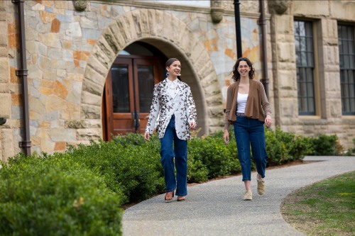 Nkeke Harris, left, and Aliza Kopans walk in front of Freidman Hall
