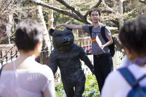 Brown student pointing to sculpture