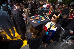 Graduate cap adorned with colorful pins